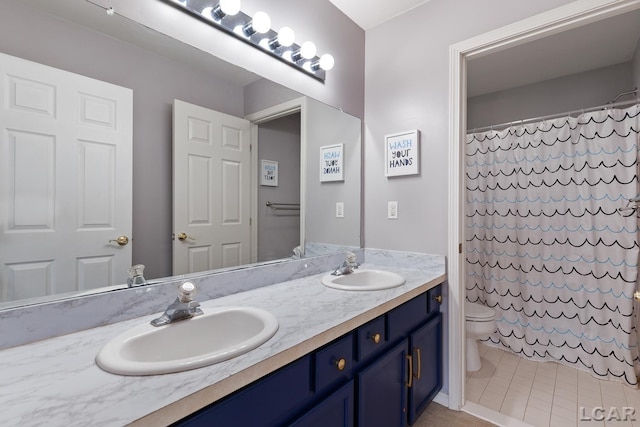 bathroom featuring toilet, curtained shower, double vanity, and a sink