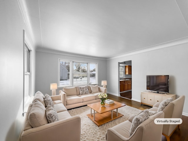 living room with baseboards, dark wood finished floors, and ornamental molding