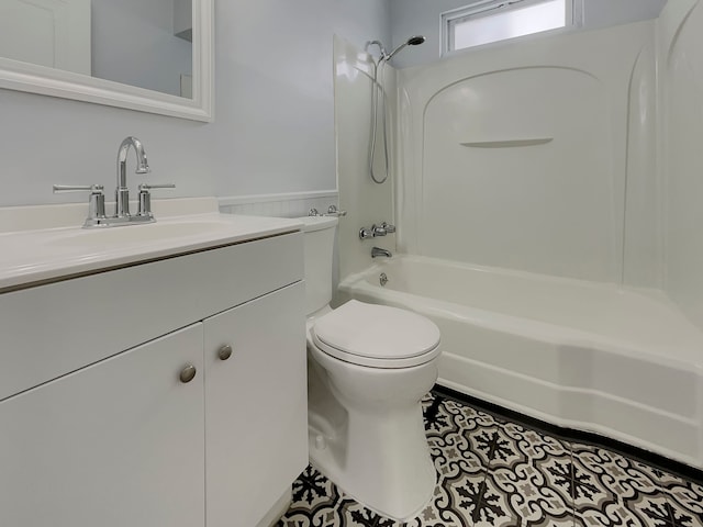 bathroom with toilet, a wainscoted wall, washtub / shower combination, and vanity