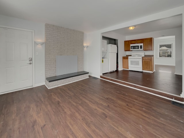 unfurnished living room featuring a fireplace, baseboards, and dark wood finished floors