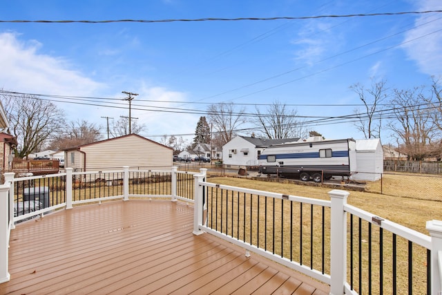 wooden terrace featuring a residential view, fence, and a yard