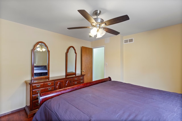 bedroom featuring ceiling fan, wood finished floors, and visible vents