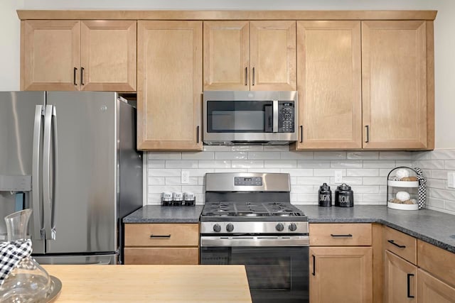 3628 Trumbull St Unit 11, Detroit, MI 48208 - kitchen with stainless steel appliances, decorative backsplash, dark countertops, and light brown cabinetry