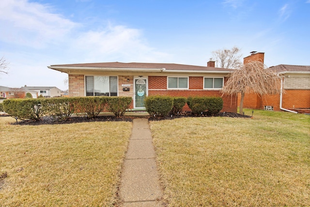 ranch-style home with brick siding and a front lawn