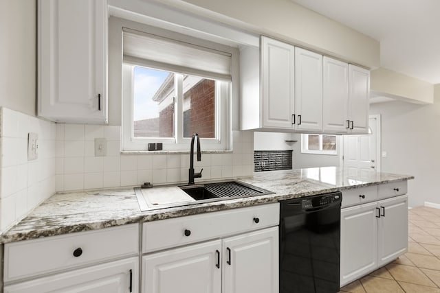 kitchen with black dishwasher, decorative backsplash, white cabinetry, a sink, and light tile patterned flooring