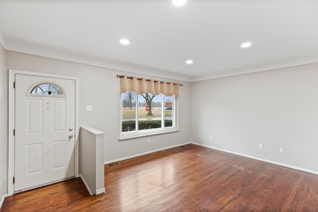 entrance foyer featuring recessed lighting, dark wood finished floors, visible vents, and baseboards