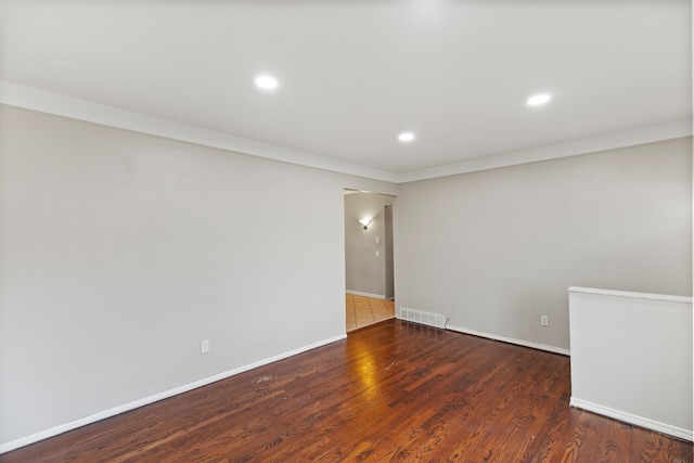 empty room with visible vents, baseboards, wood finished floors, and recessed lighting