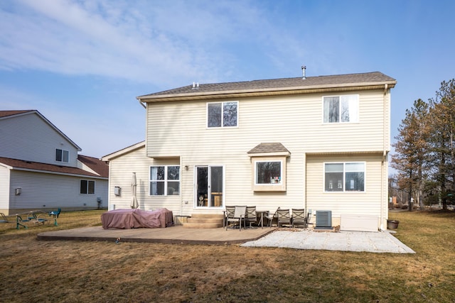 back of property with entry steps, a patio area, a yard, and cooling unit