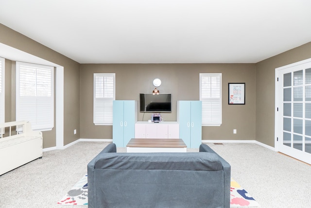 living area with baseboards and carpet flooring