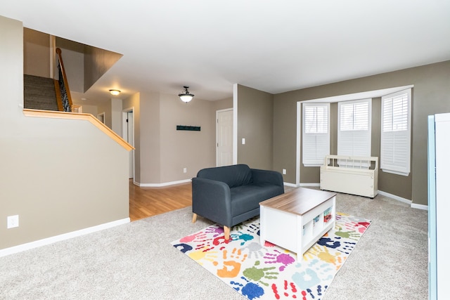 living area with light colored carpet and baseboards