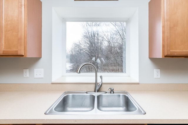 kitchen with light countertops and a sink