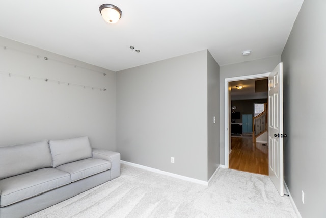 sitting room with carpet flooring and baseboards