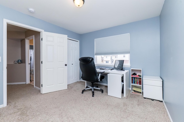 carpeted home office with baseboards