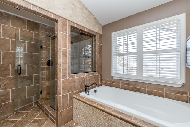 full bathroom featuring a shower stall, vaulted ceiling, and a bath