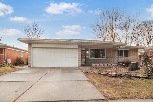 ranch-style home featuring a garage, driveway, and brick siding