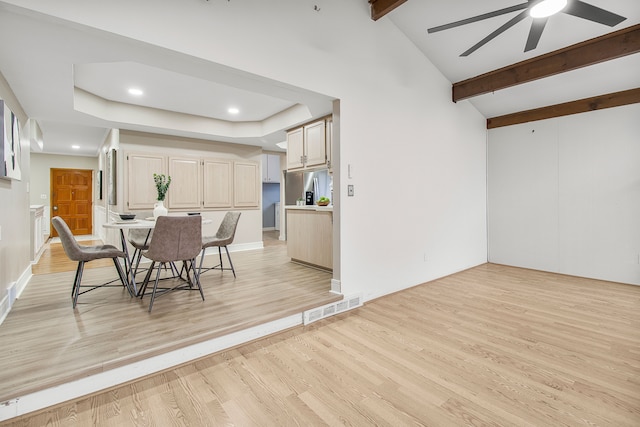 dining area with vaulted ceiling with beams, light wood finished floors, ceiling fan, and visible vents