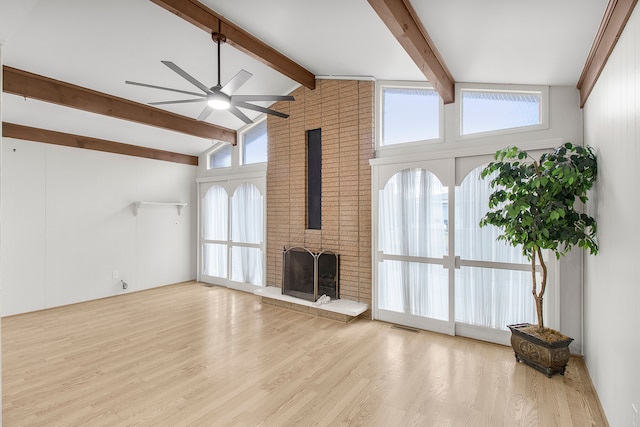 unfurnished living room with high vaulted ceiling, ceiling fan, beamed ceiling, and wood finished floors