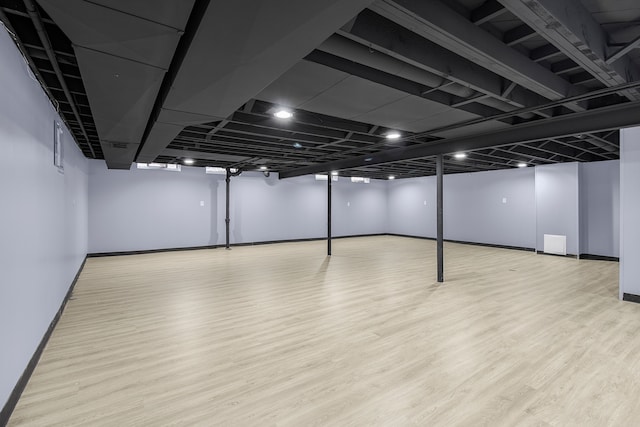 finished basement featuring baseboards and wood finished floors