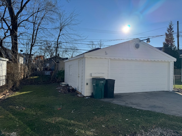 detached garage featuring fence