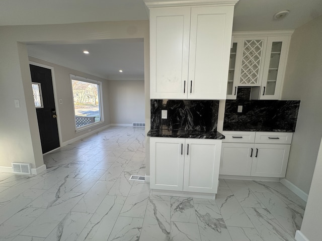 kitchen featuring marble finish floor, visible vents, and decorative backsplash