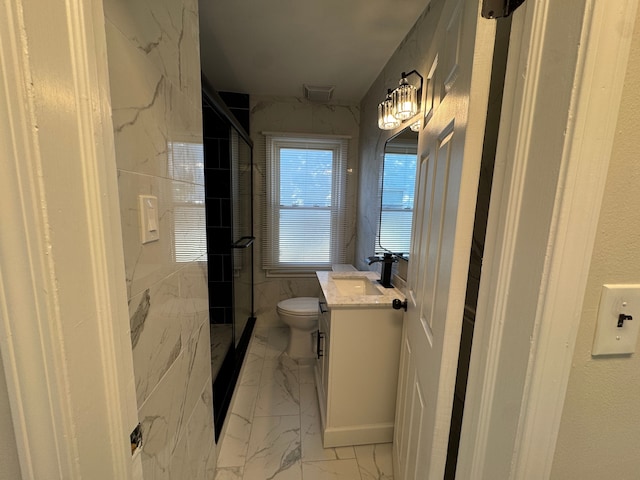 bathroom featuring a stall shower, marble finish floor, vanity, and toilet