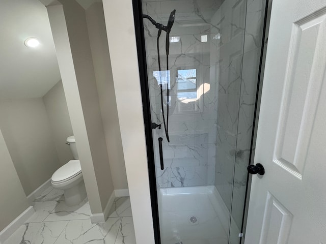 bathroom featuring marble finish floor, a marble finish shower, toilet, and baseboards