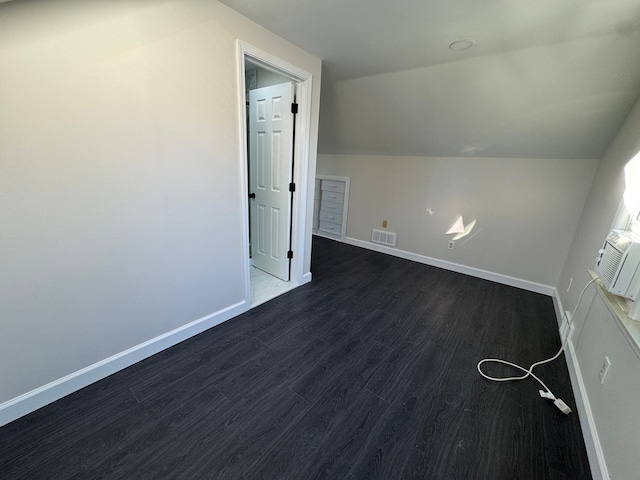 bonus room with lofted ceiling, dark wood finished floors, visible vents, and baseboards