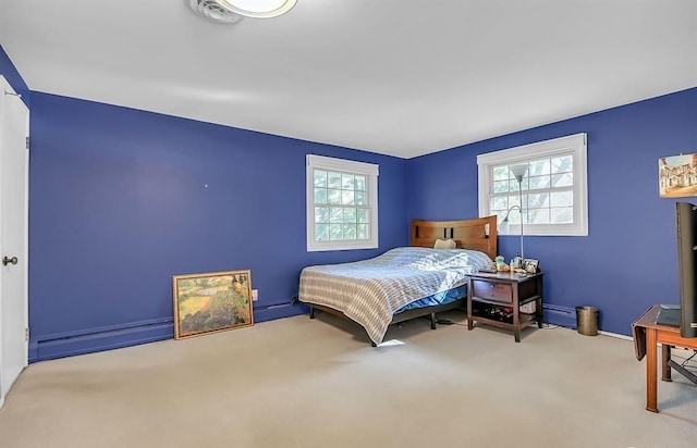 bedroom featuring a baseboard heating unit, baseboard heating, and carpet