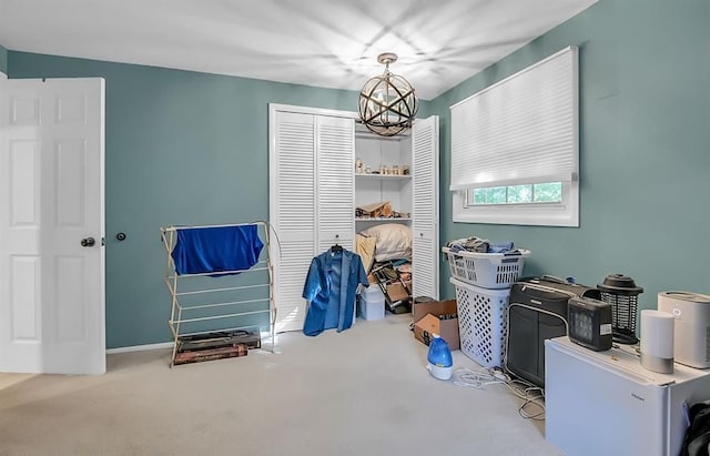 miscellaneous room featuring carpet and an inviting chandelier