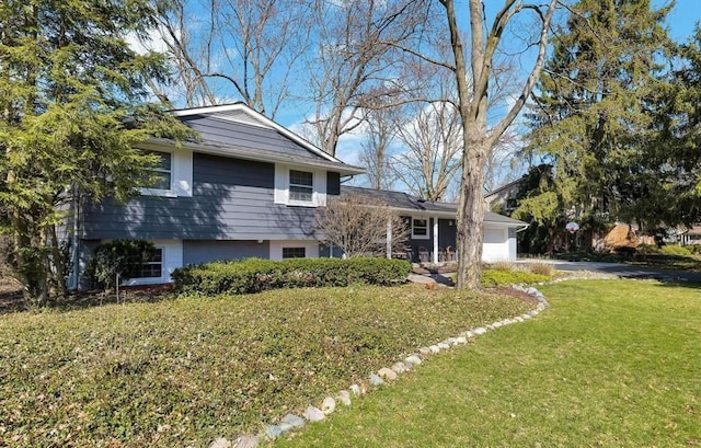 view of property exterior featuring an attached garage, driveway, and a yard