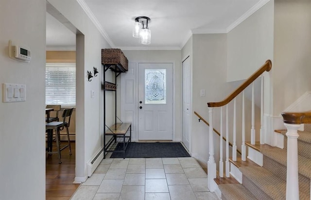 foyer entrance with a baseboard radiator, stairs, light wood-style flooring, and crown molding