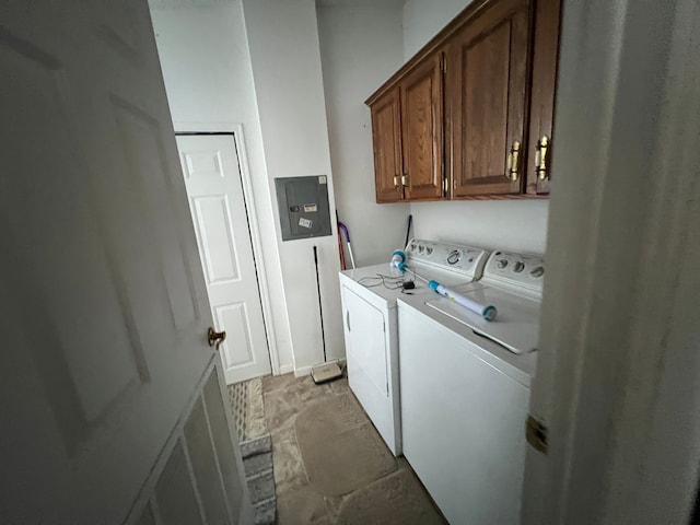 clothes washing area featuring electric panel, cabinet space, and separate washer and dryer