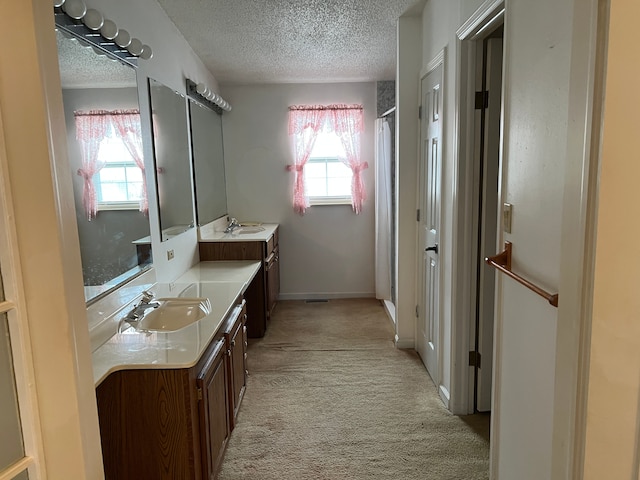 bathroom featuring curtained shower, baseboards, a textured ceiling, and vanity