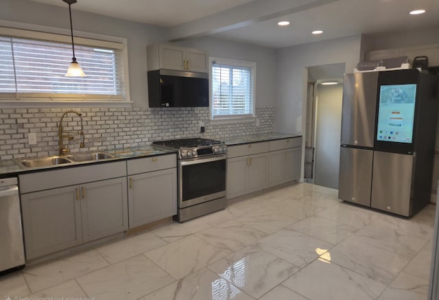 kitchen with marble finish floor, appliances with stainless steel finishes, a sink, and gray cabinetry