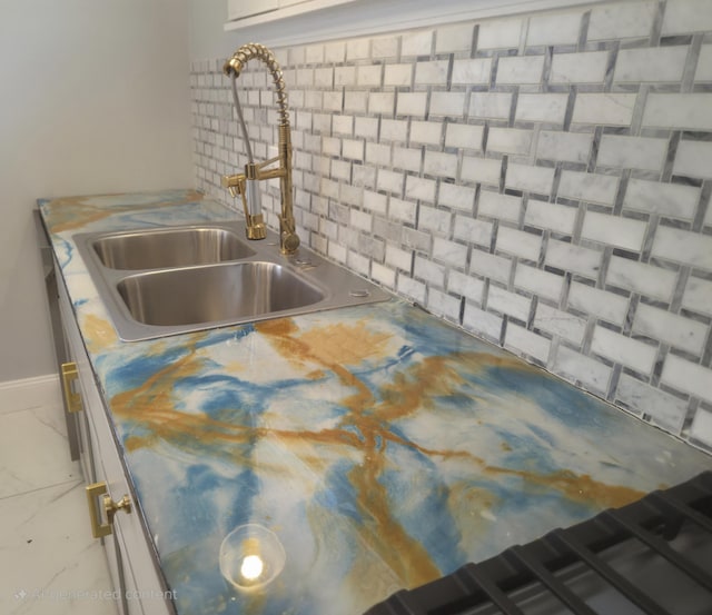 kitchen with tasteful backsplash and a sink