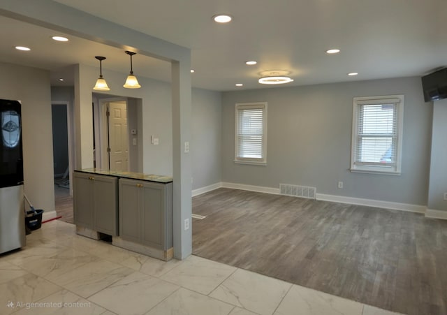 kitchen featuring recessed lighting, gray cabinets, visible vents, and marble finish floor