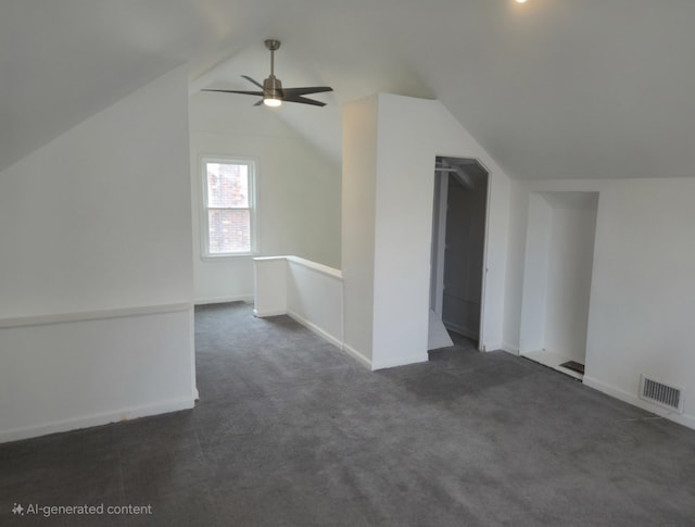 bonus room with visible vents, dark carpet, vaulted ceiling, ceiling fan, and baseboards