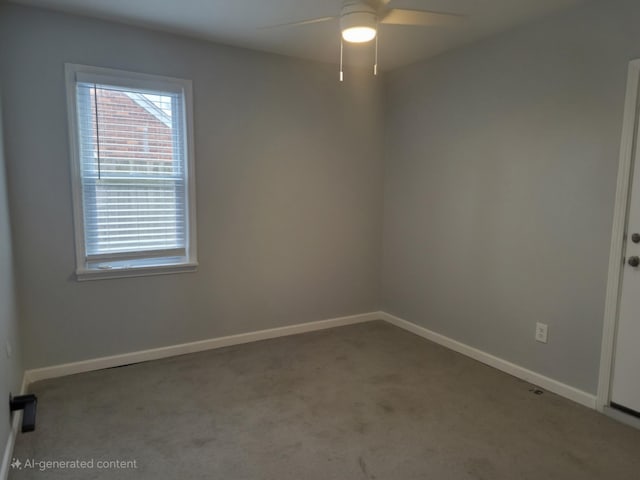 carpeted empty room with a ceiling fan and baseboards