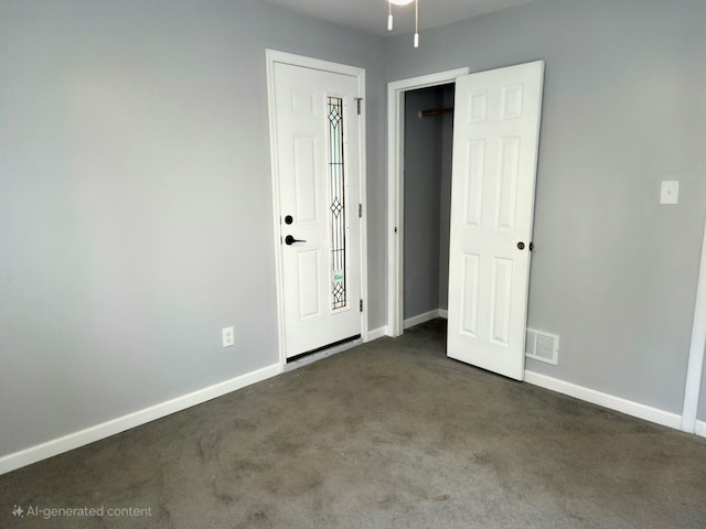 unfurnished bedroom featuring baseboards, visible vents, and dark carpet