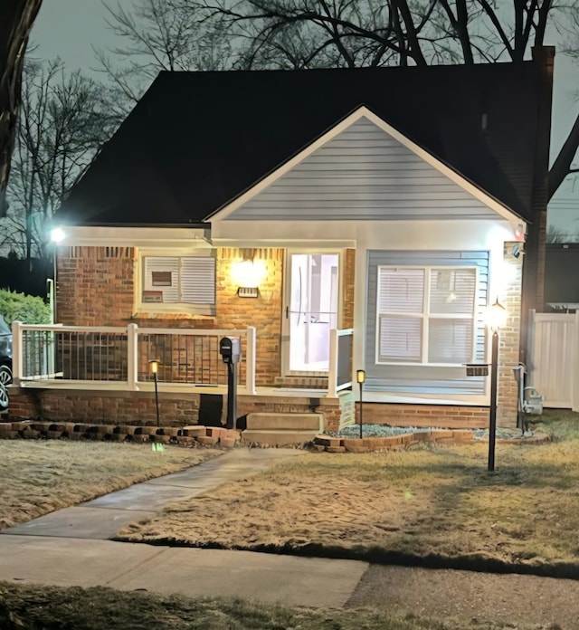 bungalow-style house with covered porch and brick siding