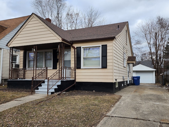 bungalow with an outbuilding, cooling unit, roof with shingles, a porch, and a garage