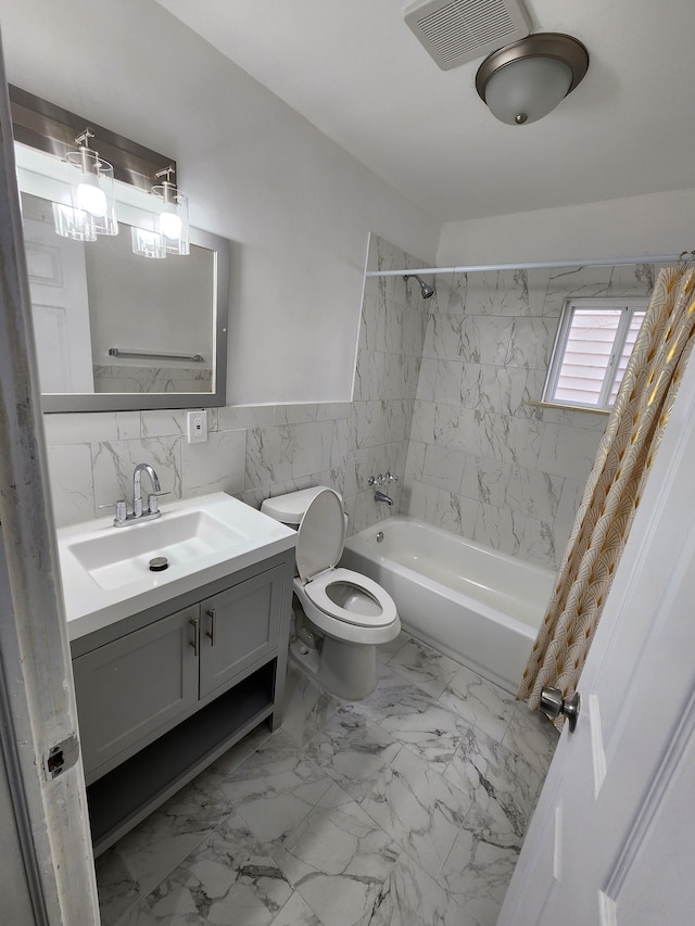 full bath with visible vents, shower / bath combo with shower curtain, tile walls, toilet, and marble finish floor