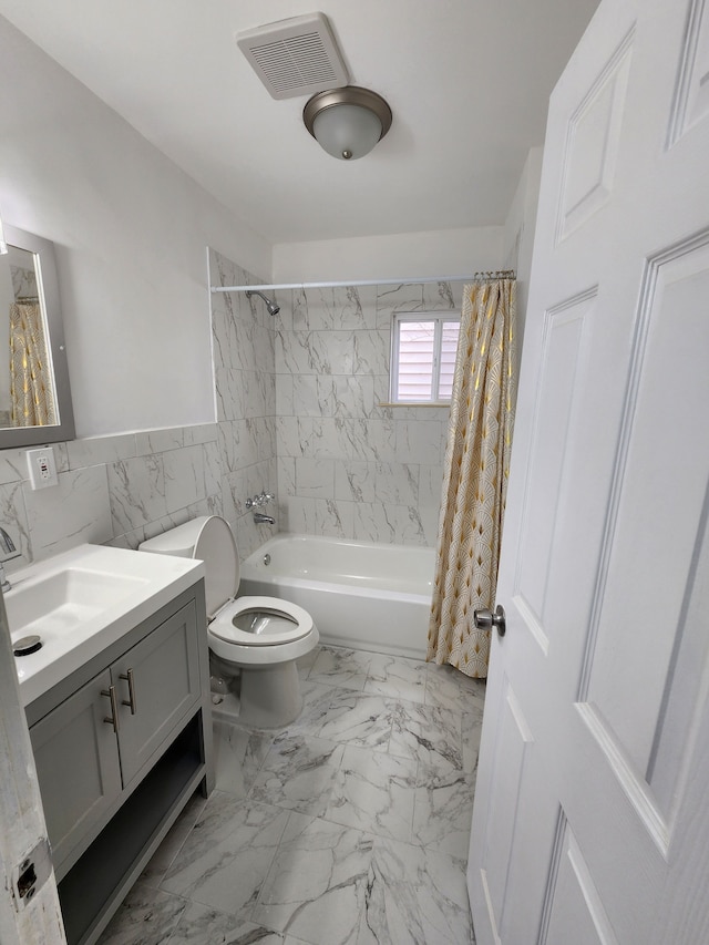 bathroom featuring vanity, visible vents, shower / tub combo, toilet, and marble finish floor