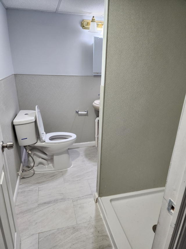 bathroom with toilet and a stall shower