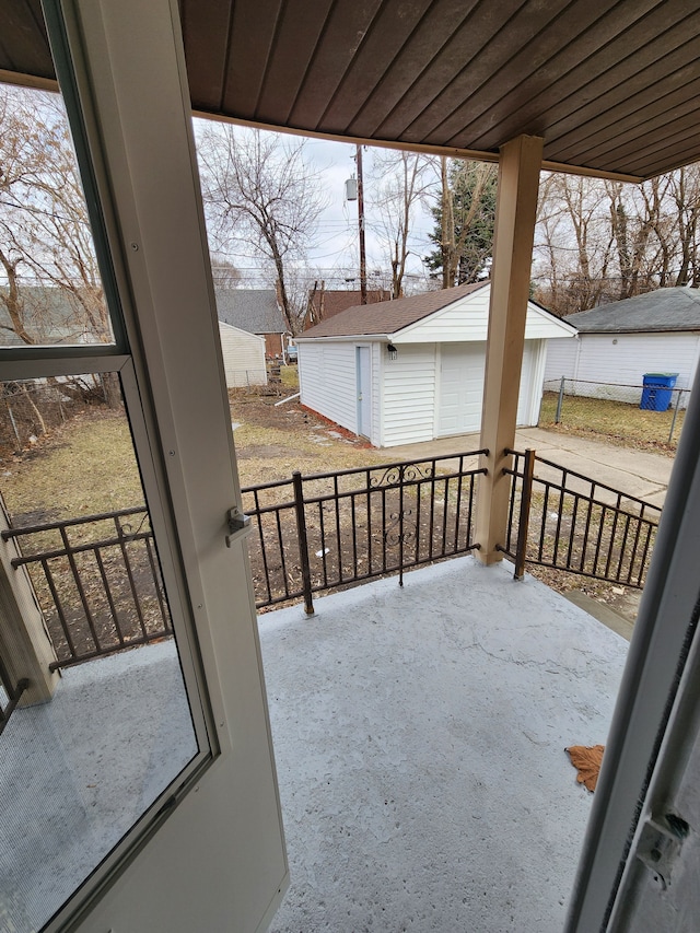 view of patio / terrace with an outbuilding and a porch