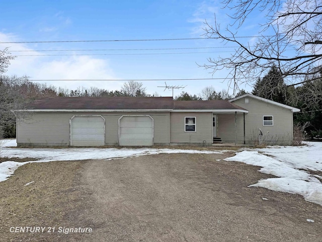 single story home with a garage and driveway