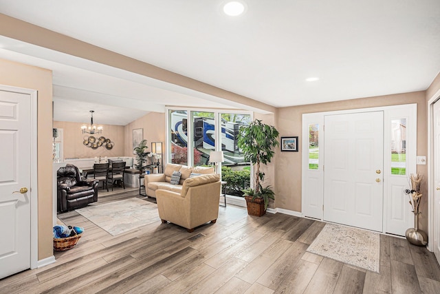 2159 Helmsford Dr, Wolverine Lake, MI 48390 - entryway with wood finished floors, a chandelier, baseboards, and recessed lighting
