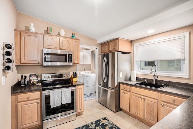 2159 Helmsford Dr, Wolverine Lake, MI 48390 - kitchen with appliances with stainless steel finishes, a sink, dark countertops, separate washer and dryer, and vaulted ceiling