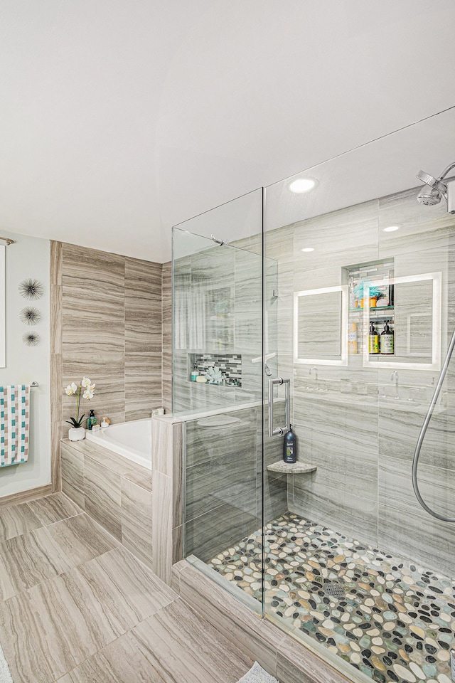 2159 Helmsford Dr, Wolverine Lake, MI 48390 - full bathroom featuring a garden tub, a shower stall, and tile patterned flooring