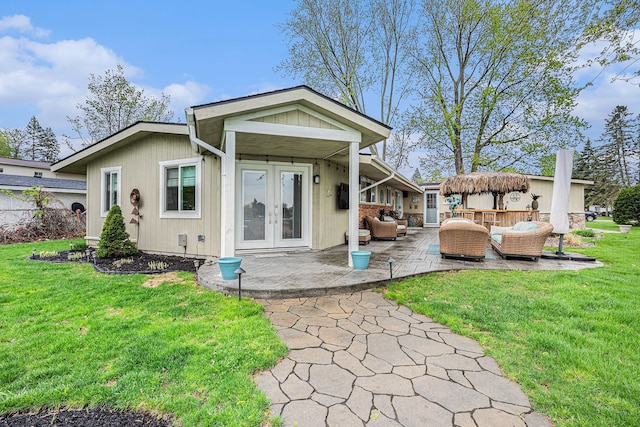 2159 Helmsford Dr, Wolverine Lake, MI 48390 - back of house with an outdoor living space, french doors, a yard, and a patio